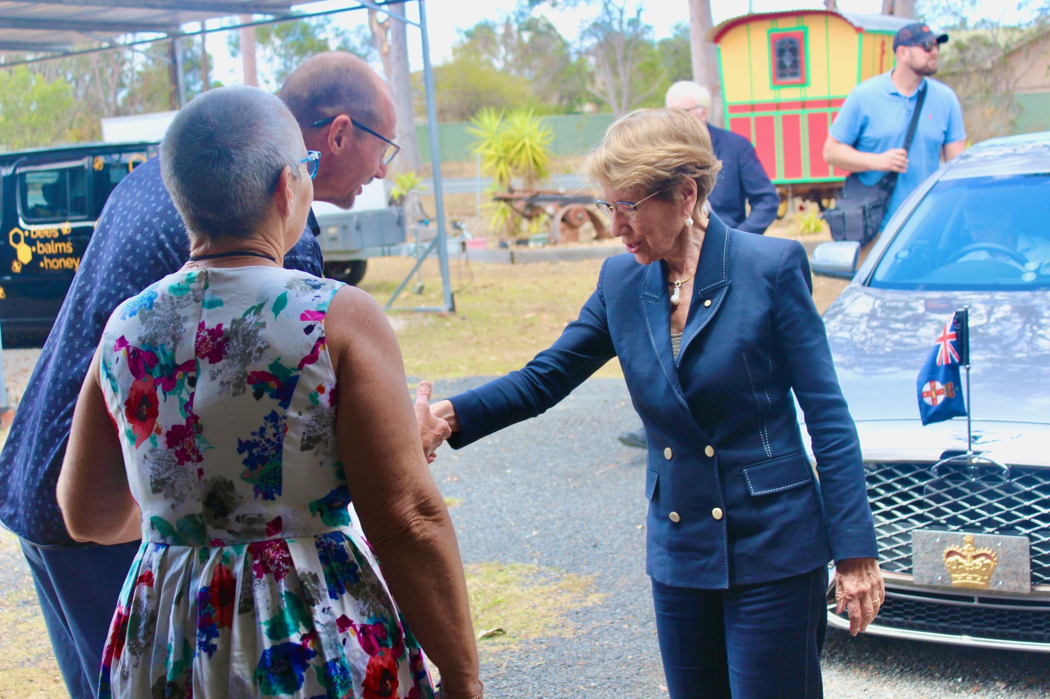 Di and Scott welcoming NSW Governor Margaret Beazley beside the official car at HoneyBee Hives