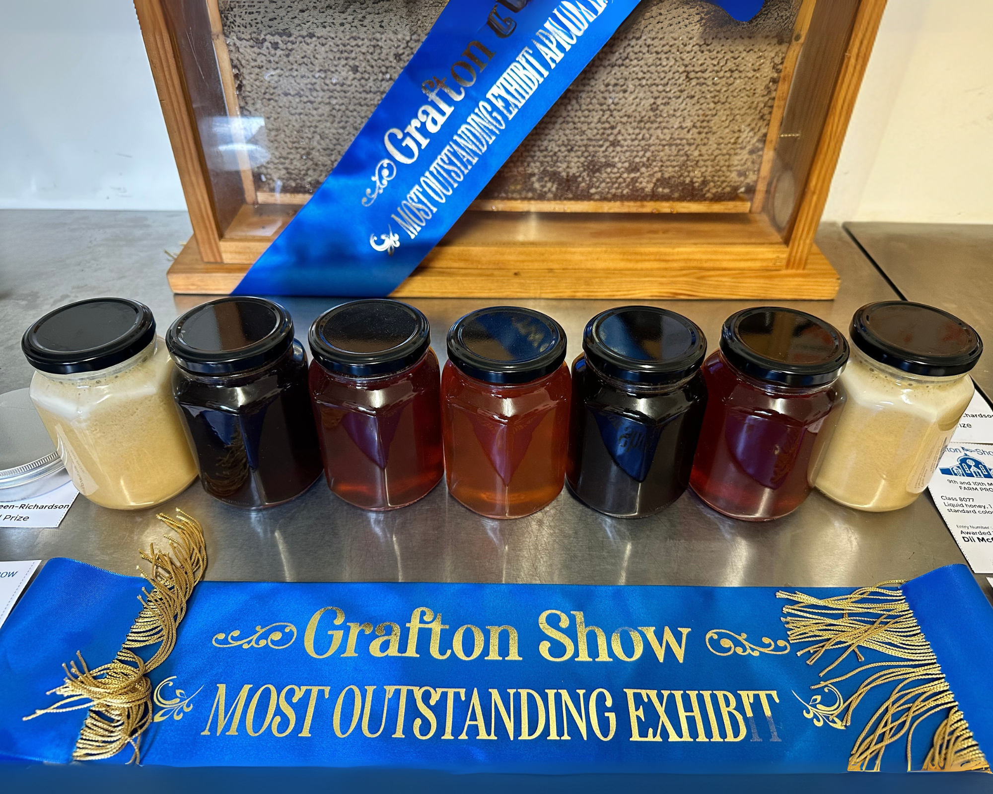 HoneyBee Hives honey display with Grafton Show prize ribbons
